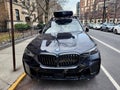 New York City, USA - February 10, 2024: BMW X5 with roof box parked outdoor, front view