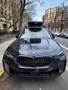 New York City, USA - February 10, 2024: BMW X5 with roof box parked outdoor, top view