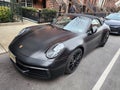 New York City, USA - February 10, 2024: Porsche 911 Carrera 4s cabriolet black car, front corner view