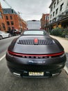 New York City, USA - February 10, 2024: Porsche 911 Carrera 4s cabriolet black car, rare view
