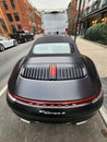 New York City, USA - February 10, 2024: Porsche 911 Carrera 4s convertible black car, back view Royalty Free Stock Photo