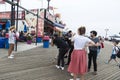 Photographer photographs a fashion model girl in Coney Island Beach, New York City, USA Royalty Free Stock Photo