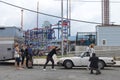 Photographer photographs a fashion model girl in Coney Island Beach, New York City, USA