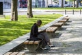 New York City, USA - June 10, 2017: African american woman using her mobile phone in a public park during coffee break