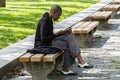 New York City, USA - June 10, 2017: African american woman using her mobile phone in a public park during coffee break