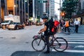 Hispanic courier on bicycle in crosswalk in New York City