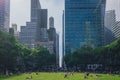 Locals enjoying a early summer day in Bryant Park inbetween skyscrapers of Manhattan