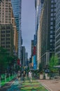 Locals enjoying a early summer day in Garment District Urban Garden un Broadway inbetween skyscrapers of Manhattan