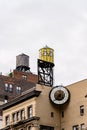 Low angle view of water towers and clock against sky in New York