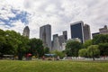 People walking in the Central Park with the New York skyline in the background, in the city of New York Royalty Free Stock Photo