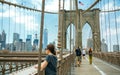 Tourists taking photos in Brooklyn Bridge in New York City Royalty Free Stock Photo