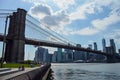 New York City, USA - June10, 2017: View of Brooklyn bridge an manhattan skyline from DUMBO district with people enjoing in a Royalty Free Stock Photo