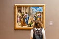 Woman looking at painting at Metropolitan Museum of Art
