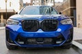 New York City, USA - March 25, 2024: BMW X3 M vibrant blue color car parked outdoor, front view