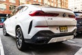 New York City, USA - March 15, 2024: BMW X6 modern white car parked outdoor, back side view