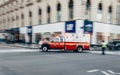 New York City, USA - March 18, 2017: FDNY Ambulance flashing lights siren blasting speed through midtown rush hour traffic in