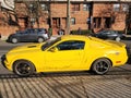 New York City, USA - March 18, 2024: Ford Mustang GT coupe yellow sportscar outdoor, side view