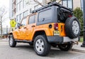 New York City, USA - March 31, 2024: 2012 Jeep Wrangler Unlimited Sahara yellow car parked outdoor, rare view