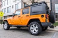 New York City, USA - March 31, 2024: 2012 Jeep Wrangler Unlimited Sahara yellow car parked outdoor, side corner view