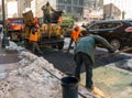 New York City, USA - March 17, 2017 - Road construction crew and equipment laying a new asphalt surface Royalty Free Stock Photo