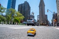 Yellow new york taxi with the famous Flat Iron Building in the background Royalty Free Stock Photo
