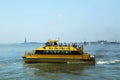 New York City Water Taxi in the front of Statue of Liberty and Ellis Island Royalty Free Stock Photo