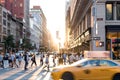 New York City yellow taxi cab speeds past the crowds of people in Midtown Manhattan