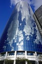 New York, New York: Clouds in a blue sky reflected in the steel and glass facade of a modern skyscraper Royalty Free Stock Photo