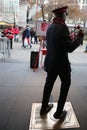 Salvation Army soldier performs for collections in midtown Manhattan. Royalty Free Stock Photo