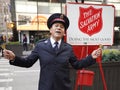 Salvation Army soldier performs for collections in midtown Manhattan during holidays season Royalty Free Stock Photo