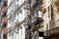 New York houses facades with fire escape stairs, sunny day Royalty Free Stock Photo