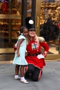 A doorman dressed as a toy soldier stands outside newly reopened the FAO Schwarz flagship store at Rockefeller Plaza