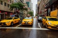 NEW YORK - JULY 2017: Taxi cars in Times Square, a busy tourist intersection of commerce Advertisements and a famous street of New Royalty Free Stock Photo