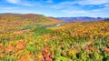 New York landscape aerial of colorful fall forests and mountains with small lake