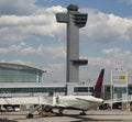 Air Traffic Control Tower and Delta Airlines plane on tarmac at Terminal 4 at JFK International Airport Royalty Free Stock Photo