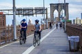 Bicyclists and pedestrians crossing empty Brooklyn Bridge during the coronavirus COVID-19 pandemic lockdown in New York City Royalty Free Stock Photo