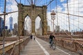 Bicyclists and pedestrians crossing empty Brooklyn Bridge during the coronavirus COVID-19 pandemic lockdown in New York City Royalty Free Stock Photo