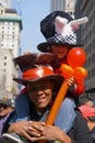 African-American man in a top hat carrying a child at the Fifth Avenue Easter Parade