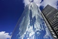 New York, New York: Clouds in a blue sky reflected in the steel and glass facade of a modern skyscraper Royalty Free Stock Photo