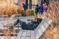 NEW YORK, NEW YORK - DECEMBER 30, 2013: Woman Lying down on Bench in High Line Path in New York, Manhattan.