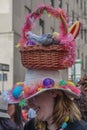 New York, New York: A smiling young woman wears an elaborate Easter bonnet