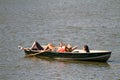 New York, New York, United States - April 15, 2011: Women friends sunbathing on the boat ride on Central Park Lake Royalty Free Stock Photo