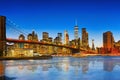New York night view of the Lower Manhattan and the Brooklyn Bridge across the East River. Royalty Free Stock Photo