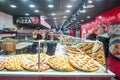 Kitchen workers with variety of Italian pizza pies on display at Little Italy Pizzeria in New York