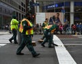 New York City Sanitation Department workers clean after horses of NYPD Mounted Unit march the 102nd Annual Veteran`s Day Parade