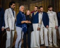 Designer Reem Acra, Joseph Abboud and male models pose on the runway during the Reem Acra Bridal Spring 2020 fashion collection