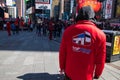 Man in red sweatshirt in Times Square Manhattan New York selling tickets for the Hop on Hop Off sightseeing bus Royalty Free Stock Photo