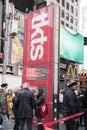 Tourists standing by the TKTS discount theater ticket box office sign in Times Square Manhattan New York City