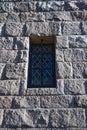 A small window with bars and leaded glass in a stone wall at Cloisters Museum in Fort Tryon Park in Washington Heights, Manhattan Royalty Free Stock Photo