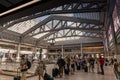 Horizontal view of people lined up for a train at the Moynihan Train Hall